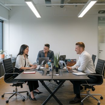 Three colleagues in a meeting at a conference table